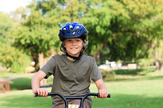 Little boy with his bike during the summer in a park