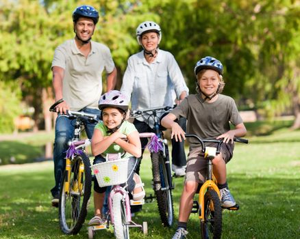 Family with their bikes in a park during the summer