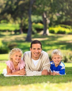 Father with his children during the summer in a park