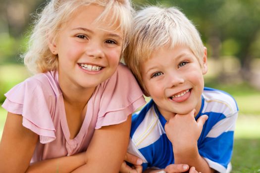 Boy with his sister in the park during the summer