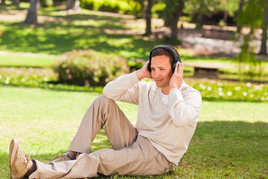 Man listening to music in the park during the summer 