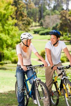 Couple in the park with their bikes during the summer 