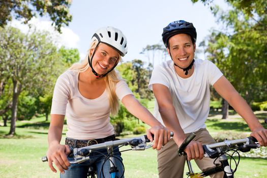 Couple in the park with their bikes during the summer 