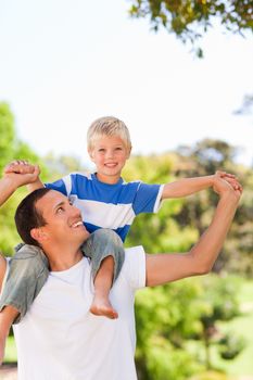 Man giving son a piggyback in a park