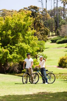 Couple with their bikes during the summer in the park