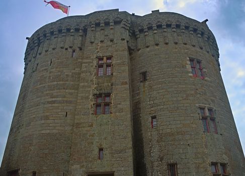 Big central stone tower with flag on top at Dinan fortress, France