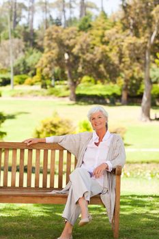Senior woman on a bench during the summer 