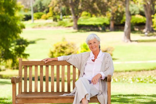 Senior woman on a bench during the summer 