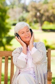 Senior woman listening to some music during the summer 