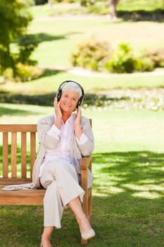 Senior woman listening to some music during the summer 