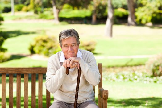 Elderly man with his walking stick during the summer