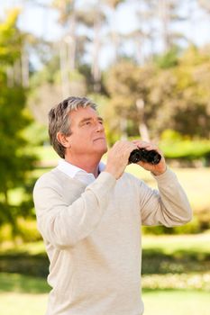 Mature man birds watching during the summer