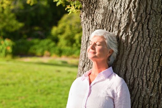 Senior woman in the park during the summer