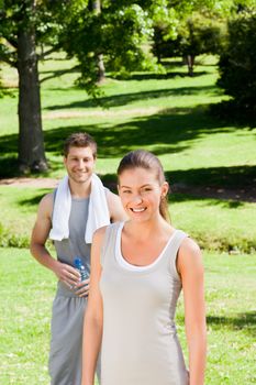 Sporty couple in the park during the summer