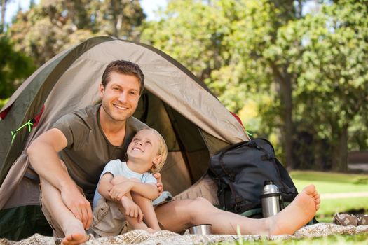 Father and his son camping during the summer