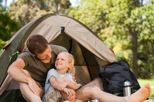 Father and his son camping during the summer