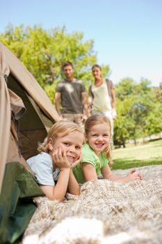 Happy family camping in the park during the summer