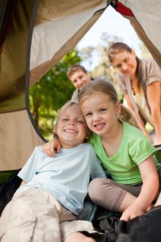 Happy family camping in the park during the summer