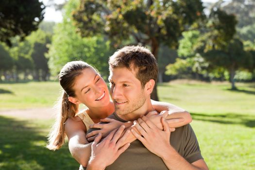 Woman hugging her handsome husband during the summer