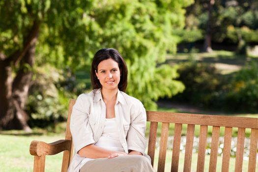 Young woman on the bench during the summer