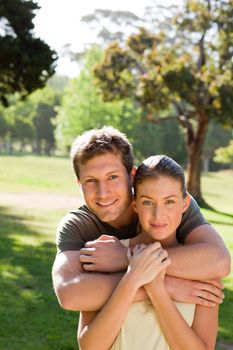 Man hugging his beautiful wife during the summer