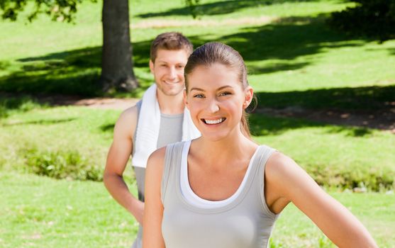 Sporty couple in the park during the summer