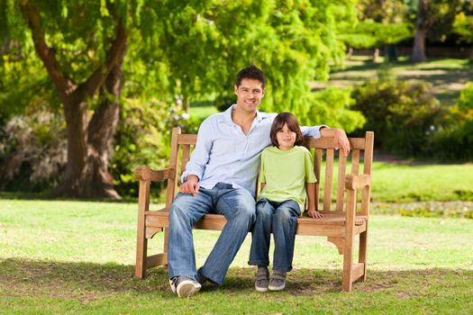 Father with his son on the bench during the summer