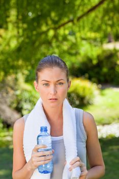 Woman drinking water after the gym during the summer