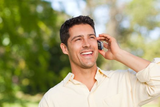 Man phoning in the park during the summer 