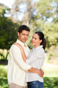 Happy lovers in the park during the summer