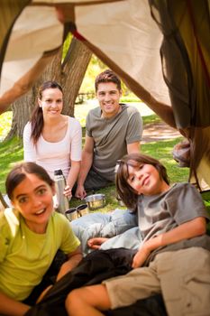 Happy family camping in the park during the summer