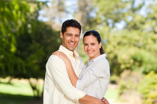 Happy lovers in the park during the summer