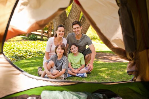 Joyful family camping in the park during the summer
