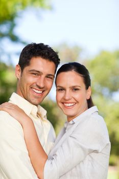 Happy lovers in the park during the summer