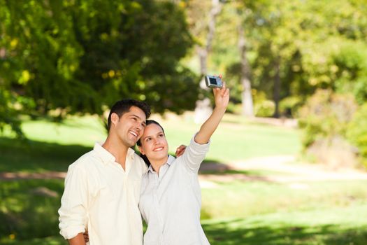 Young couple taking a photo of themselves during the summer 