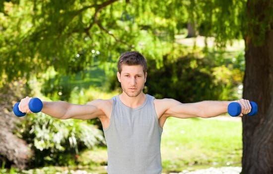 Man doing his exercises in the park during the summer