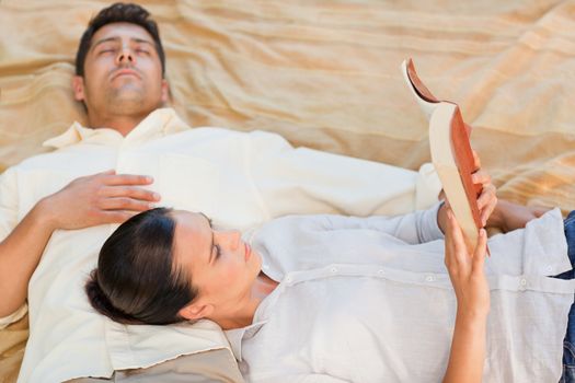 Couple reading in the park during the summer