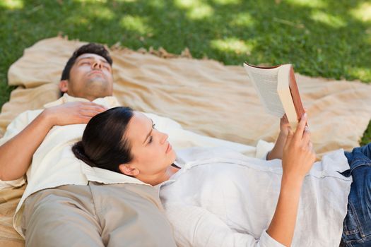 Couple reading in the park during the summer