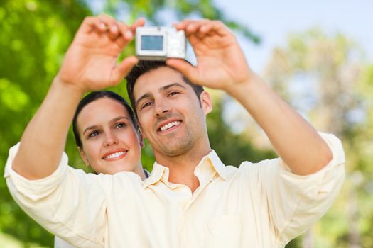 Couple taking a photo of themselves in a park