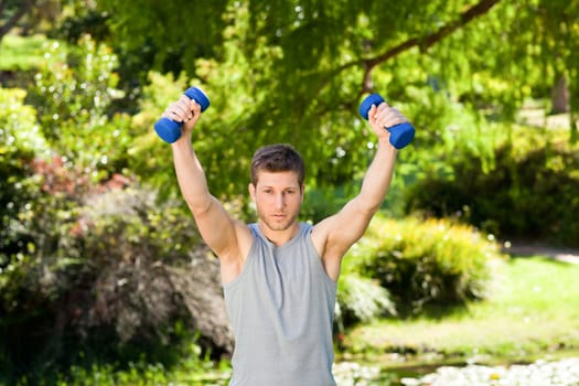 Man doing his exercises in the park during the summer