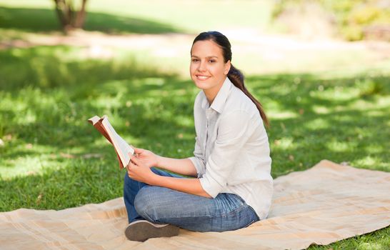 Woman reading in the park during the summer