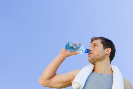 Man drinking water after the gym during the summer