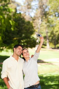 Couple taking a photo of themselves in a park