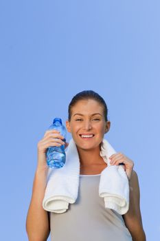 Young woman drinking water during the summer