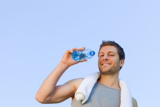 Man drinking water after the gym during the summer