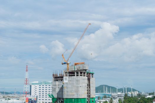 Building crane, engineering and building skyscraper under construction