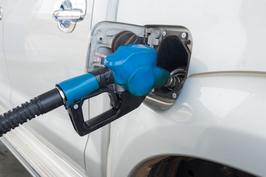 Blue Fuel nozzle to release fuel into car at gas station