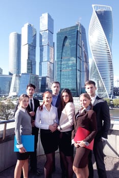 Portrait of business team outside office on skyscrapers background