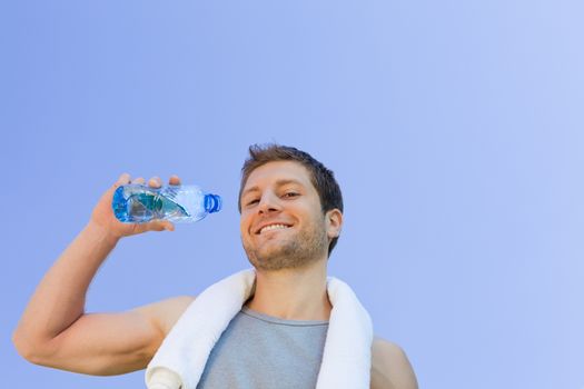 Man drinking water after the gym during the summer