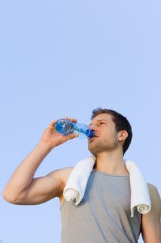 Man drinking water after the gym during the summer